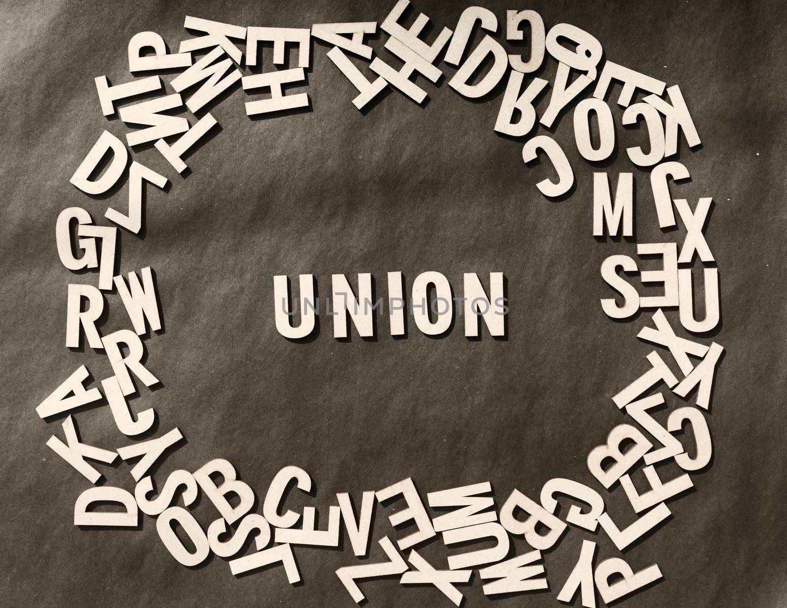 Union Word In Wooden Cube Alphabet Letters Top View On A rustic paper Background.