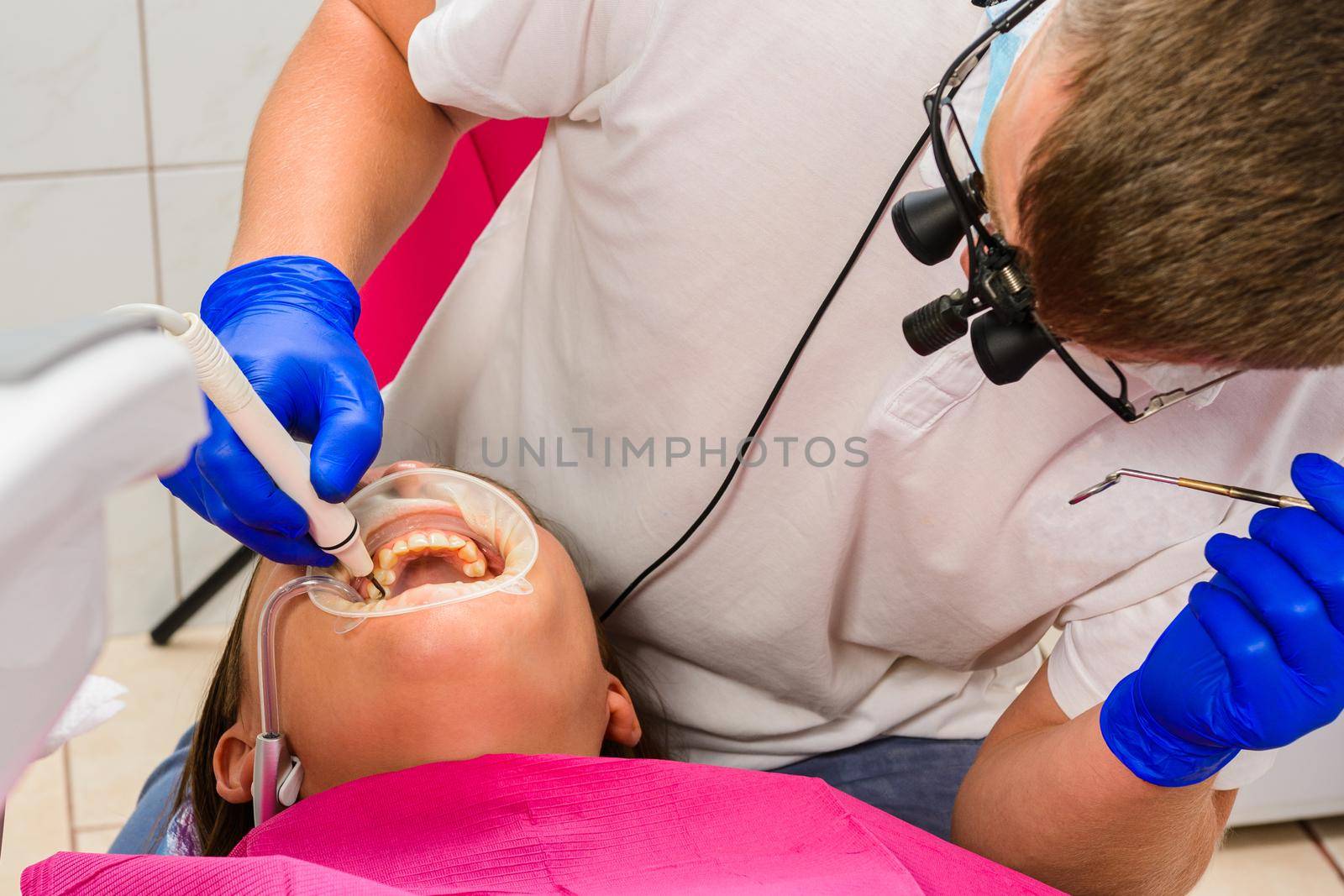 The dentist uses a scaler to remove tartar, oral hygiene.2020