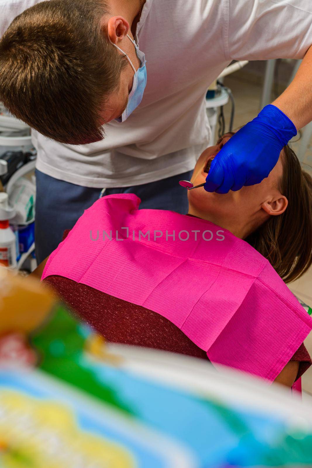 The dentist examines the oral cavity before treating the problem areas of the teeth. by Niko_Cingaryuk