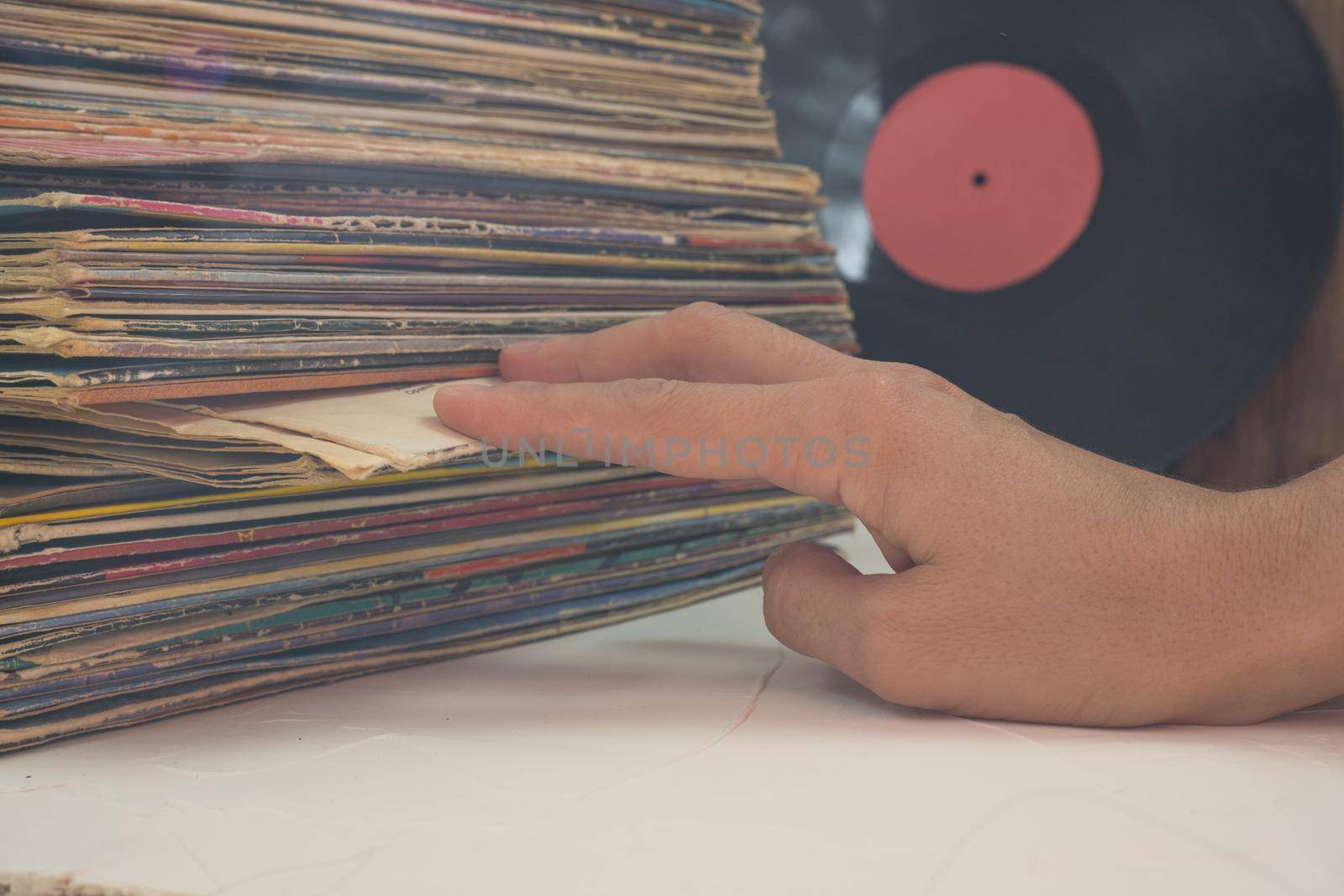 Browsing through vinyl records collection. Music background.