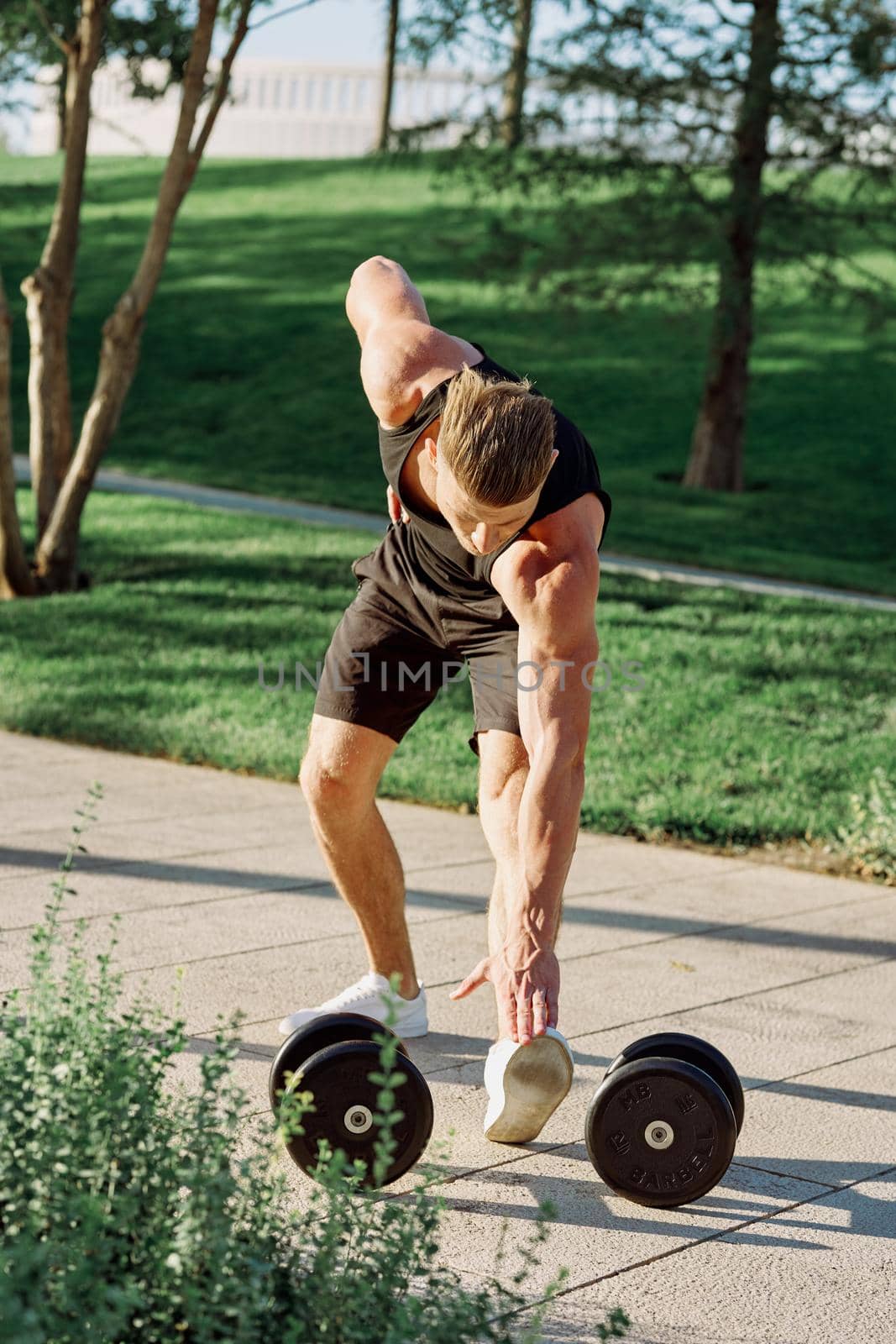 man with dumbbells in the park exercise fitness. High quality photo