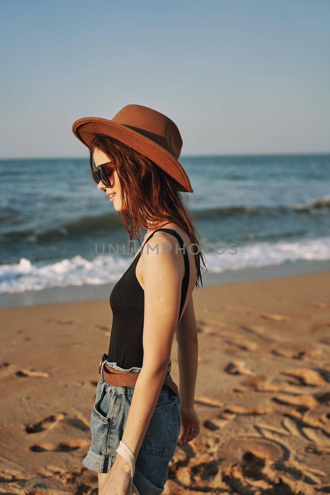 woman in trendy summer clothes by the ocean vacation sun by Vichizh