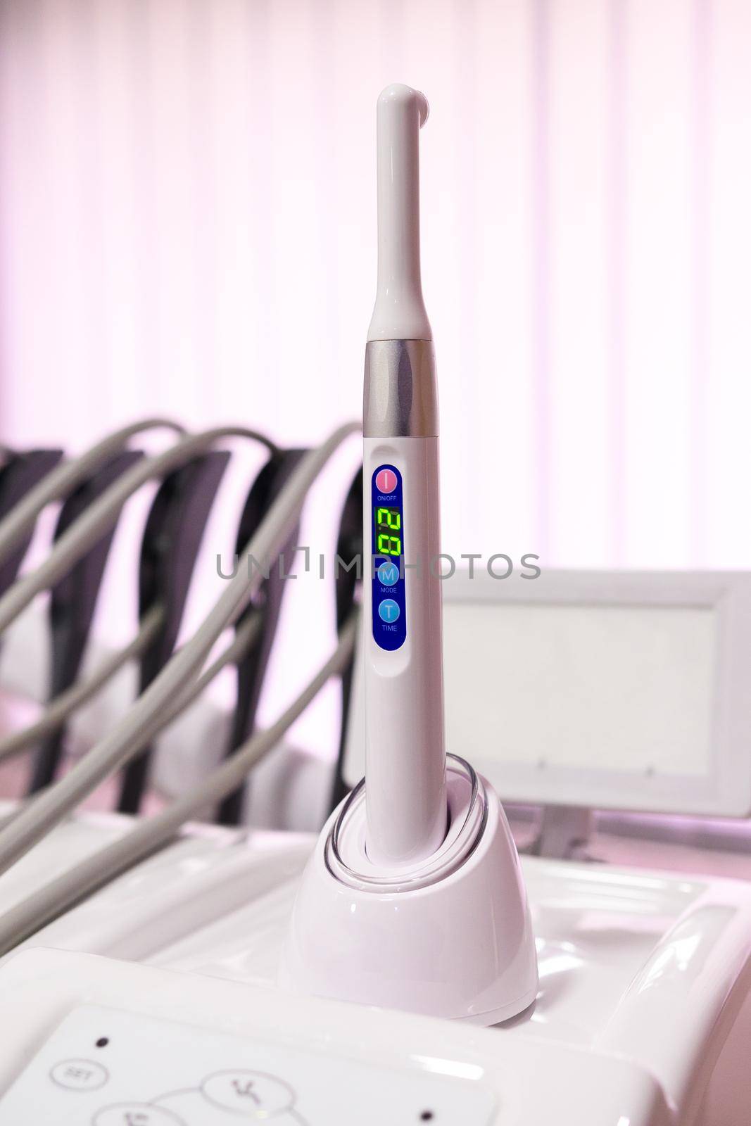 Ultraviolet caries detector on a stand, modern dental equipment. by Niko_Cingaryuk