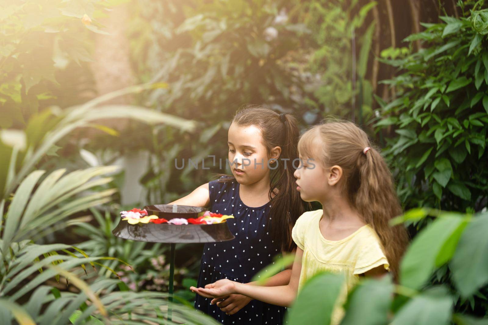 two little girls with butterflies in a greenhouse by Andelov13