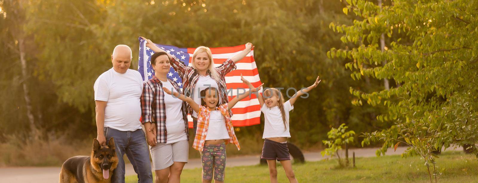 Family Posing Outdoors With American Flag by Andelov13