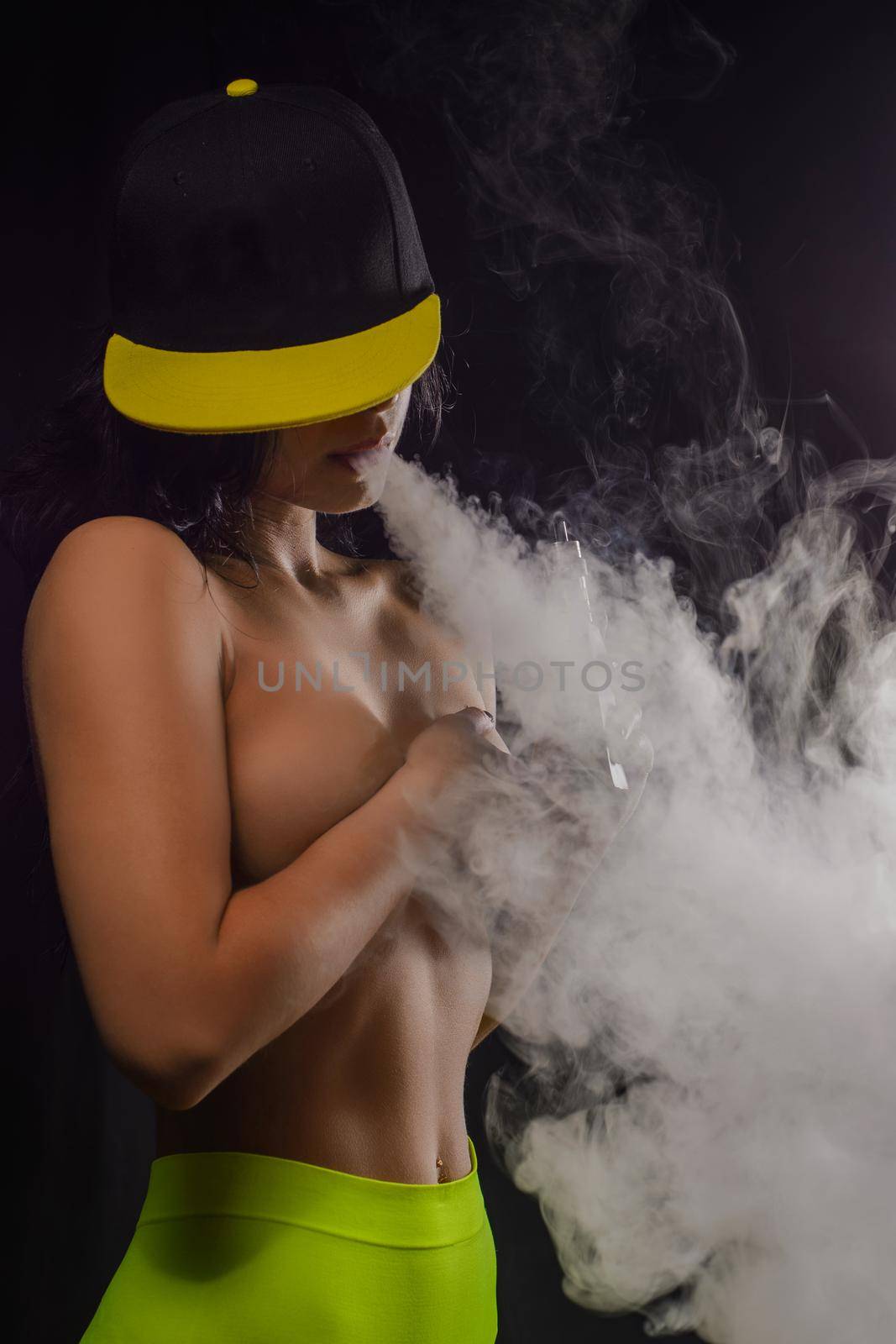 Young sexy woman smoking electronic cigarette, vape mod concept.