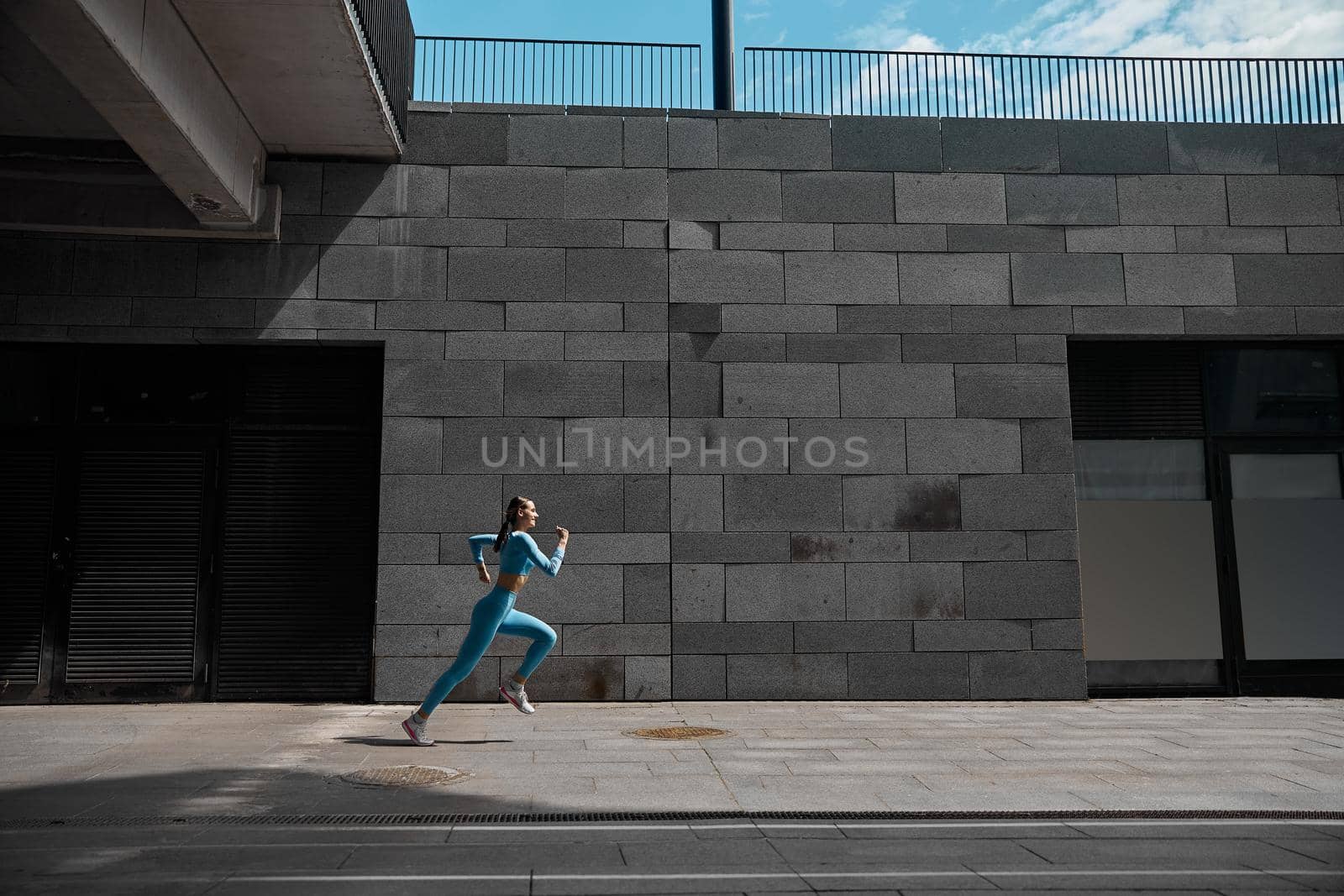 Beautiful fit young woman jogger is running outdoors