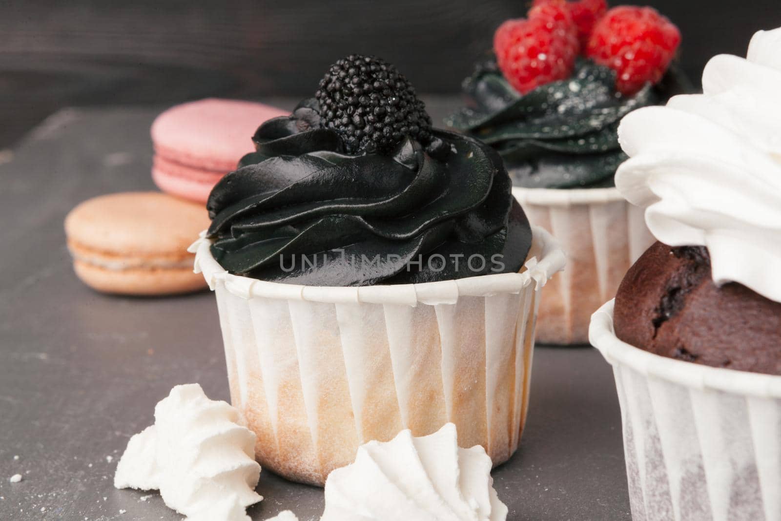 Delicious raspberry cupcakes on dark background - Handmade Sweet dessert