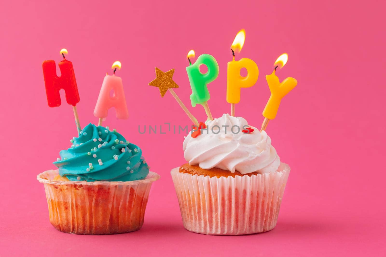 Delicious cupcakes with candles on a colored background. Festive background, birthday