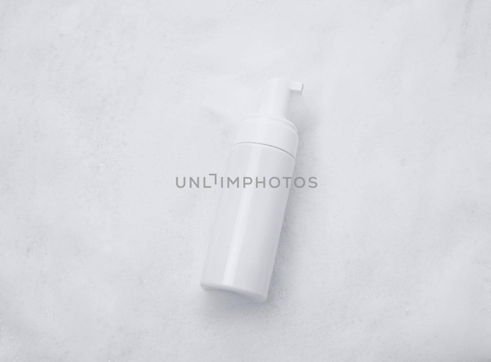 White plastic tube mockup with moisturizer cream, shampoo or facial cleanser and gentle soap foam with bubbles on marble background, top view. Treatment spa beauty skincare cosmetic product by Ekaterina34