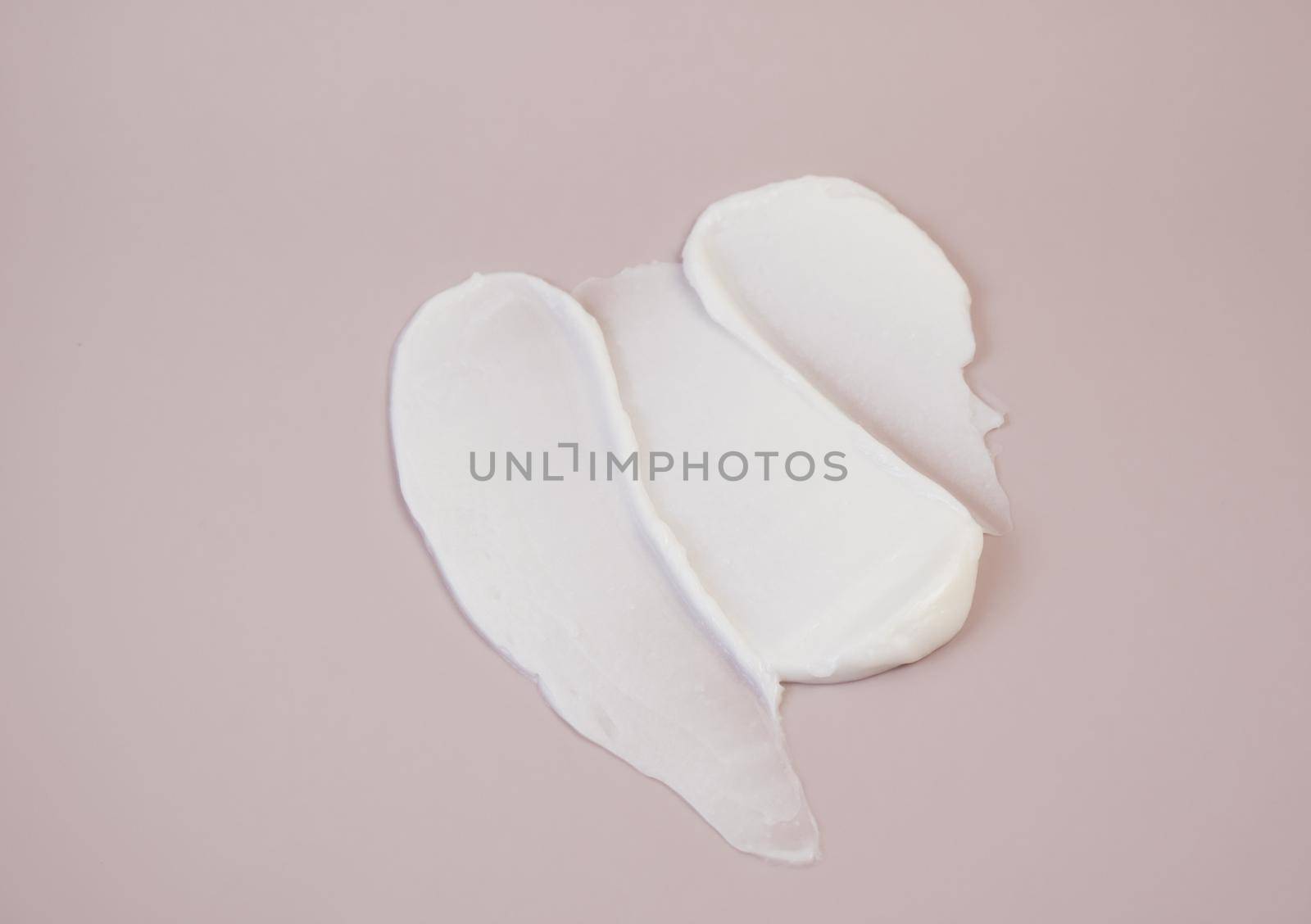 White cream texture on a pink background