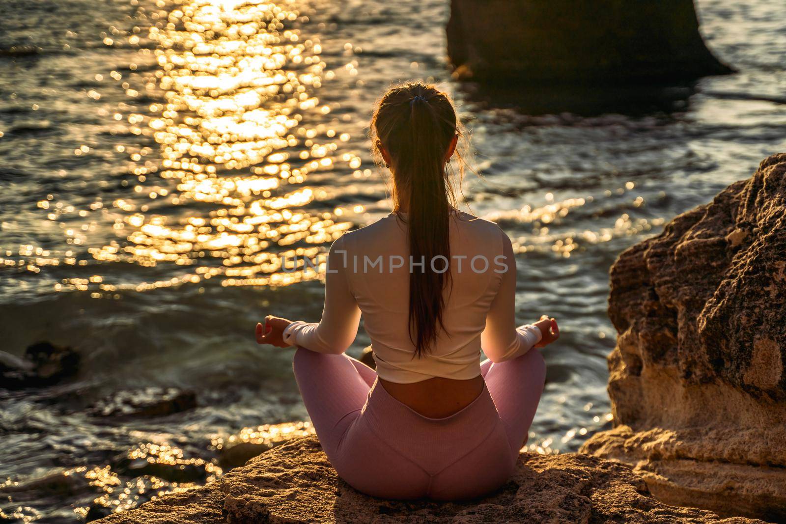 Young woman practicing yoga outdoors. Harmony and meditation concept. Healthy lifestyle.