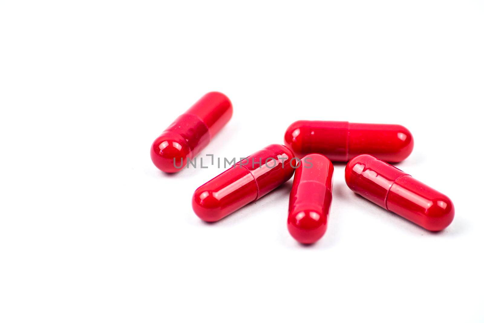 Red pills to treat Covid on white background
