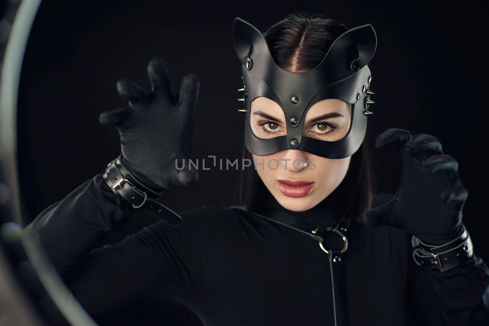 the woman in black belt and cat mask emotional portrait
