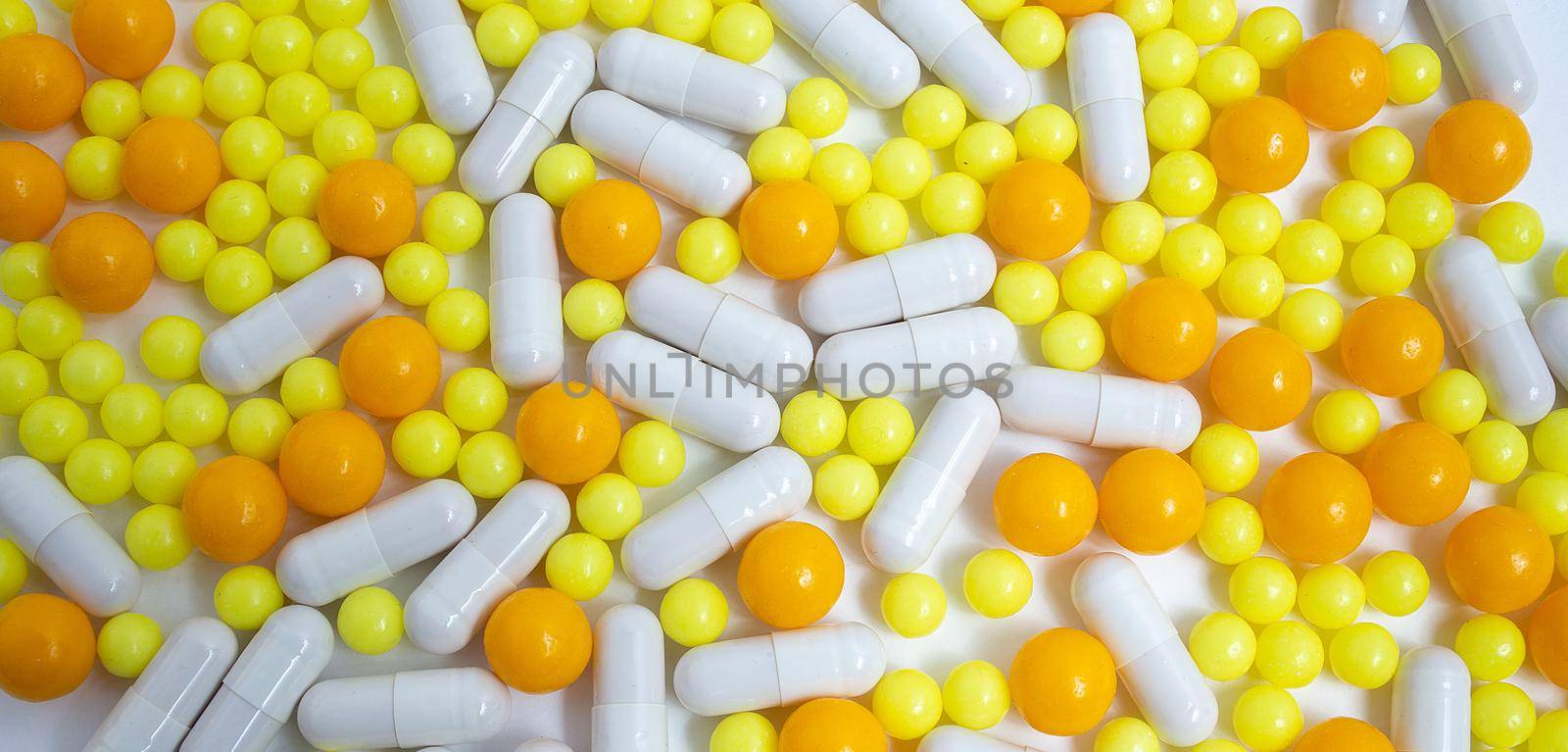 different colorful pills, capsules. Prevention, cure of influenza, coronavirus, covid-19, 2019-nCoV. yellow, orange vitamins, tablets on white background. medical healthcare, protection concept banner