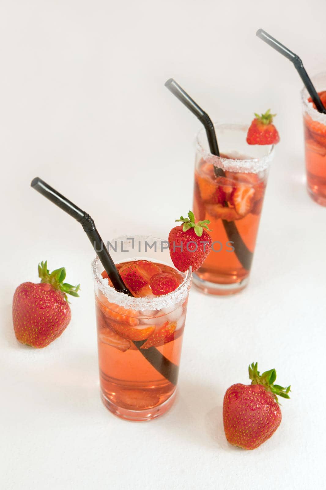 closeup of fresh strawberry water fruit and juice isolated in white background. Mexican Strawberry Water - Agua de Fresa