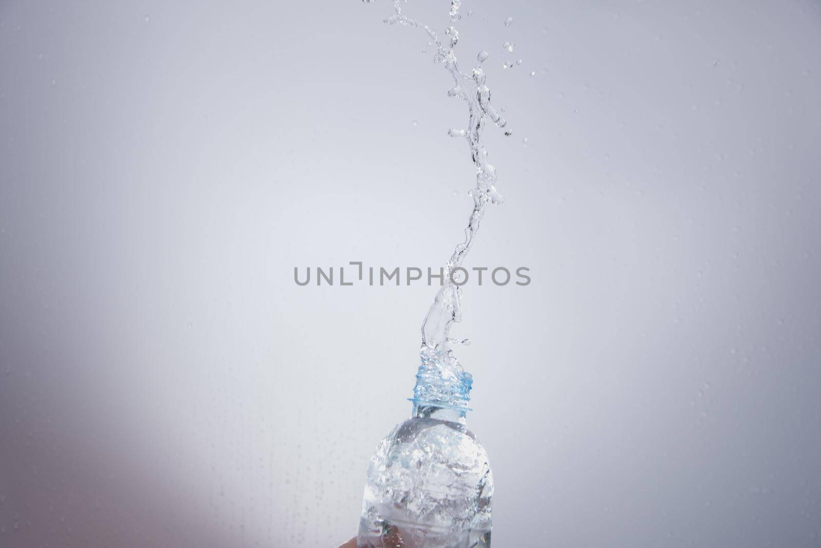 Pour water out of the bottle by yayimage
