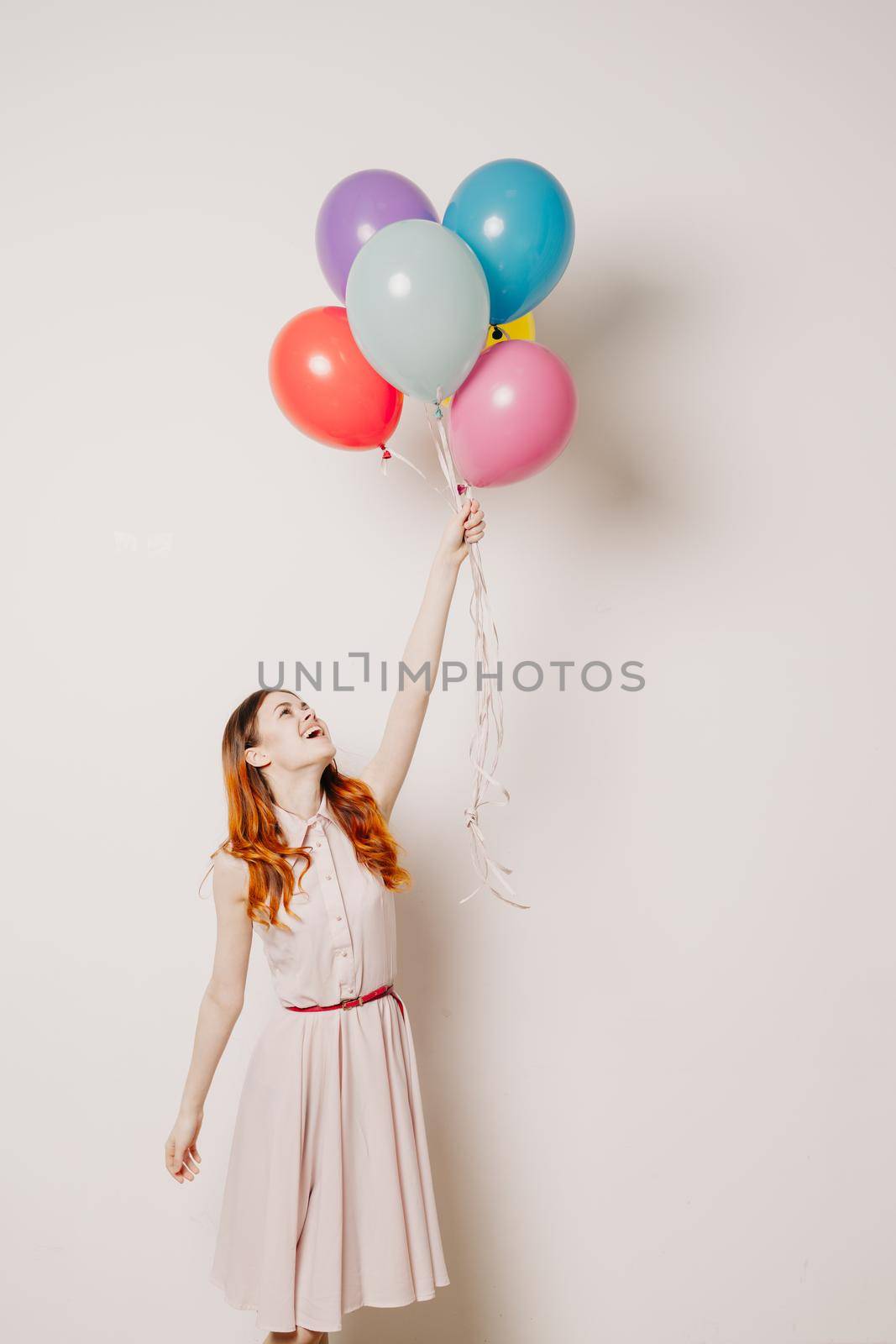 cheerful woman in a dress of colorful balloons. High quality photo