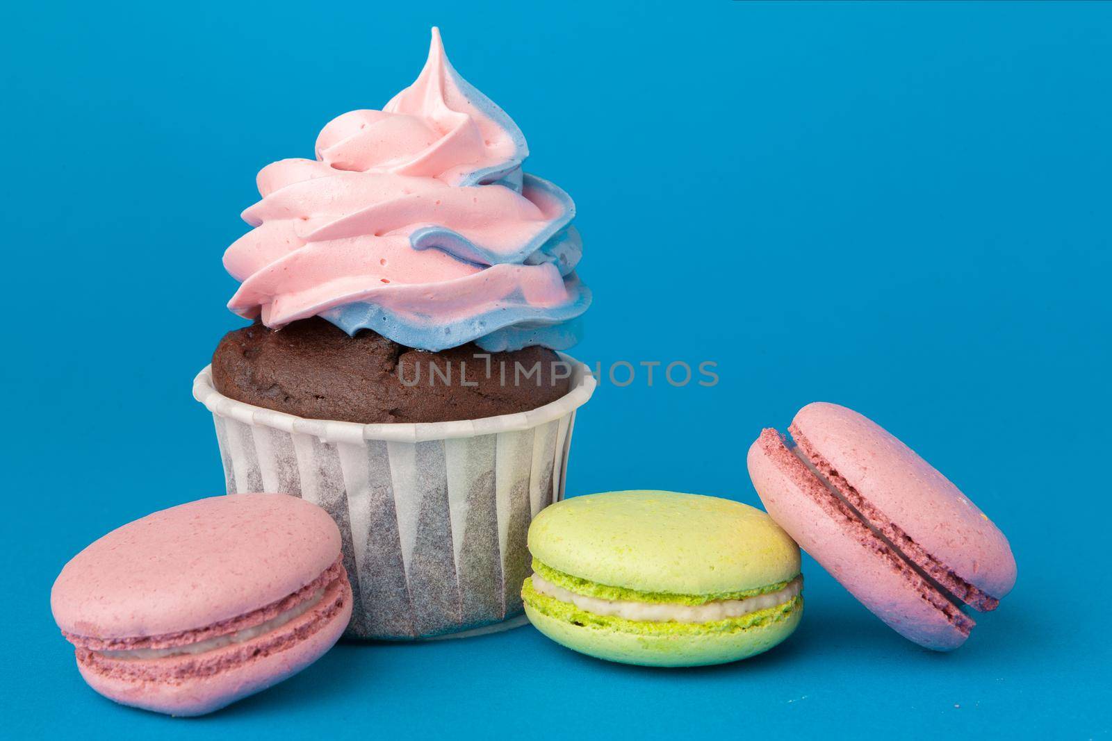 Birthday cupcakes on blue background close up