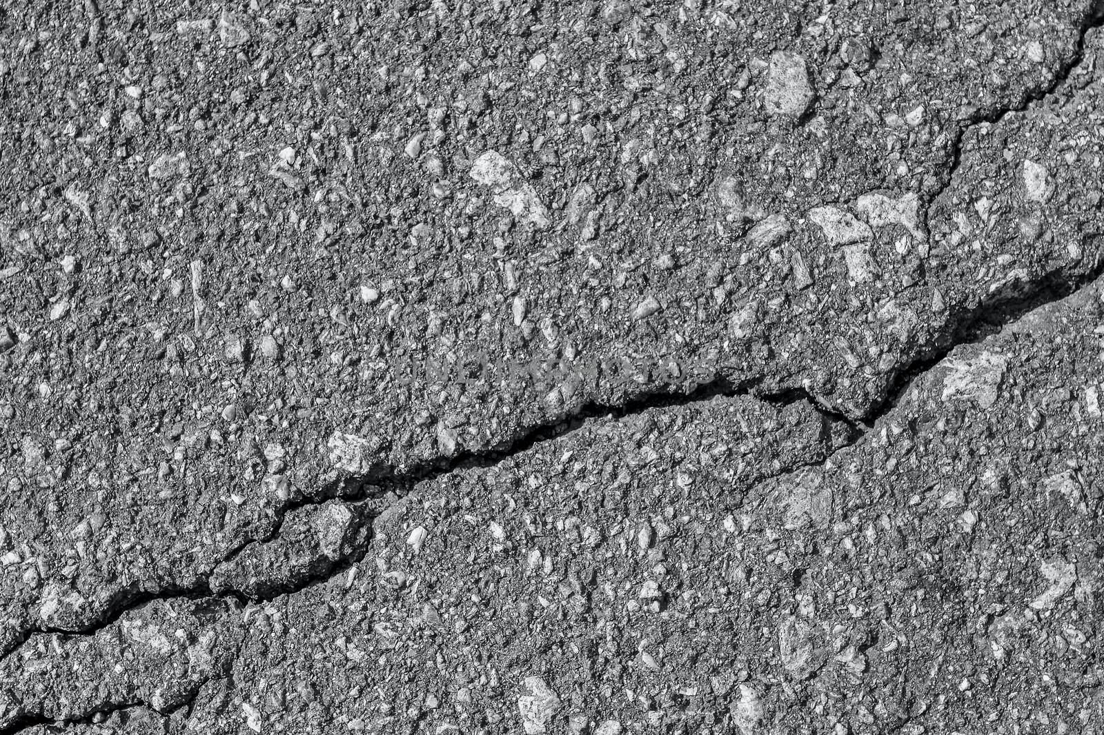 Asphalt with crack background. Old gray road for background or texture. Asphalt as abstract background or backdrop. Banner toned in trendy color of 2021 Ultimate Grey