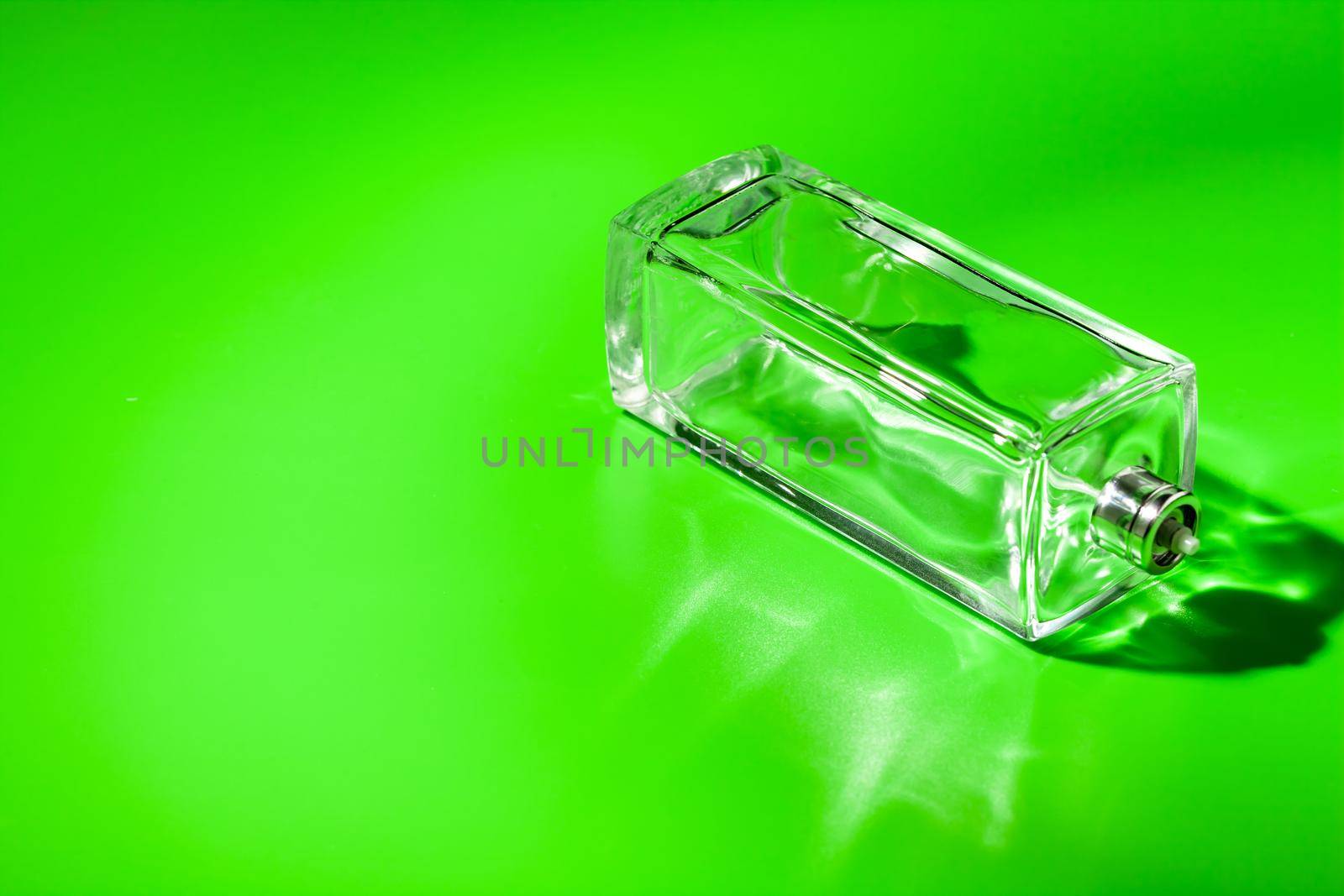 perfume glass bottle on light green background. Eau de toilette