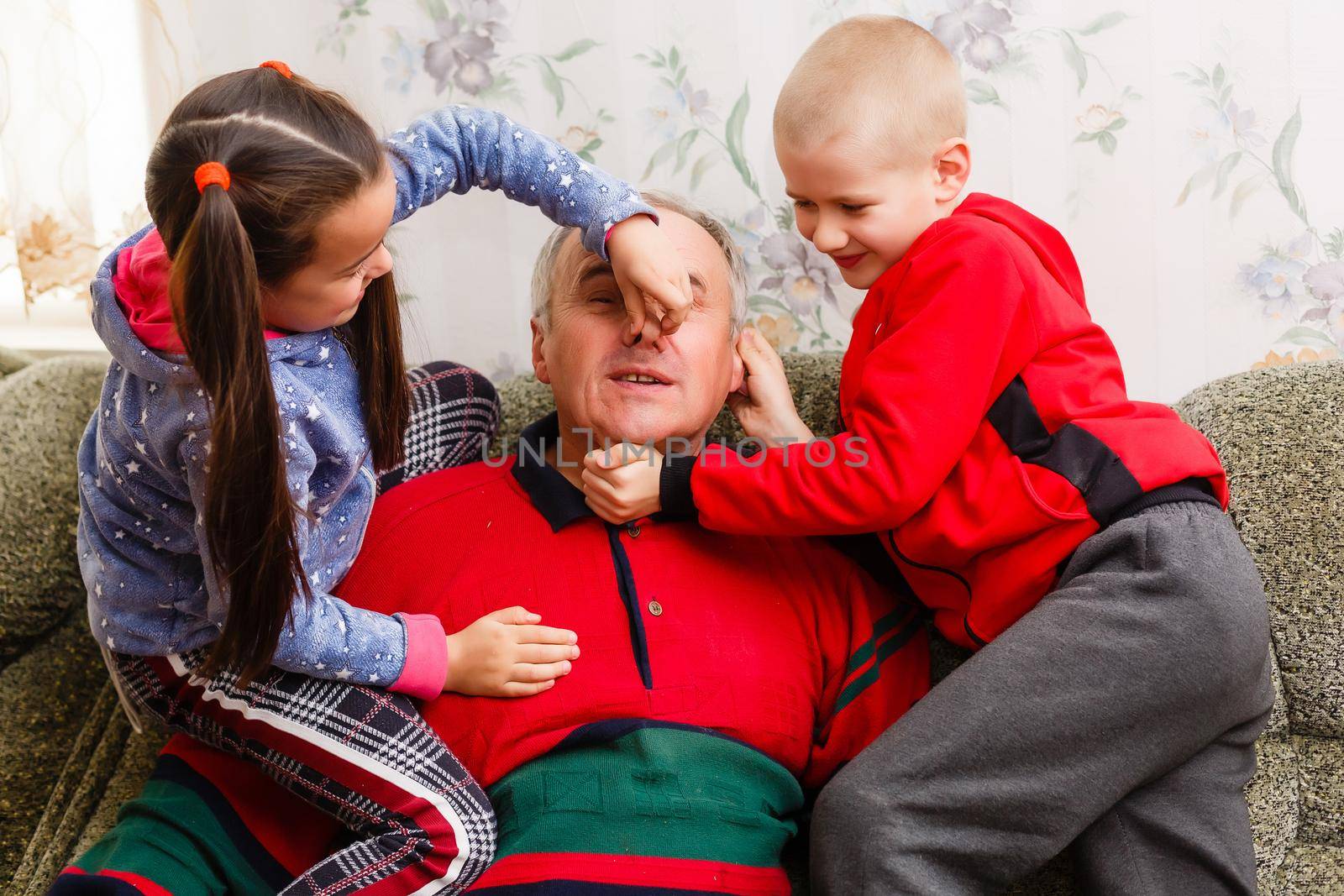 Grandparents spending time with grandchildren on couch