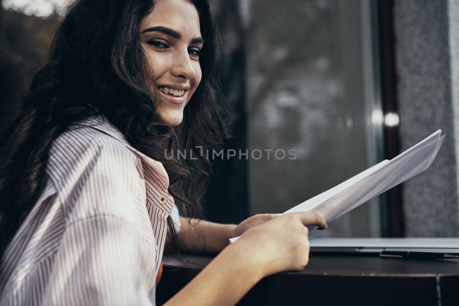 smile female student outdoor cafe in front of laptop business. High quality photo