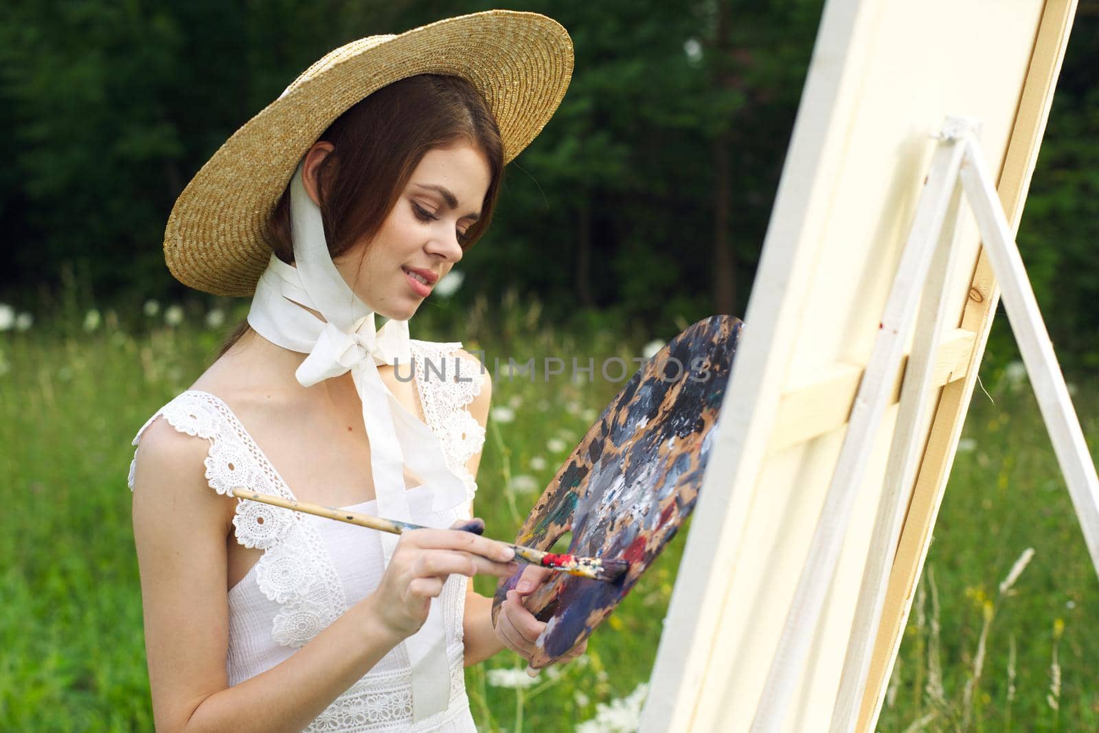 Woman in white dress outdoors artist drawing easel by Vichizh