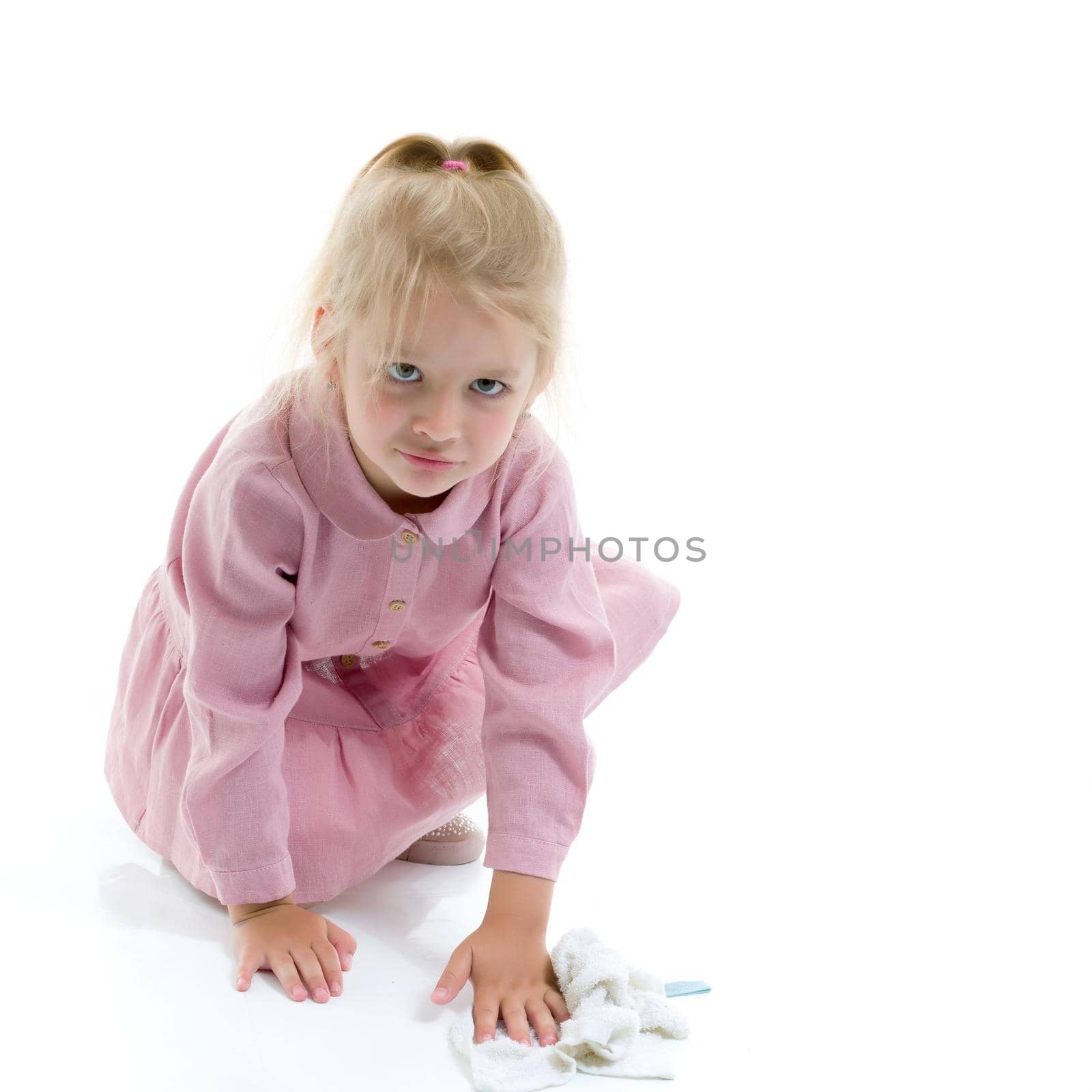 A nice little girl is sweeping the floor in the apartment. The concept of cleanliness and order, hygiene. Isolated on white background.