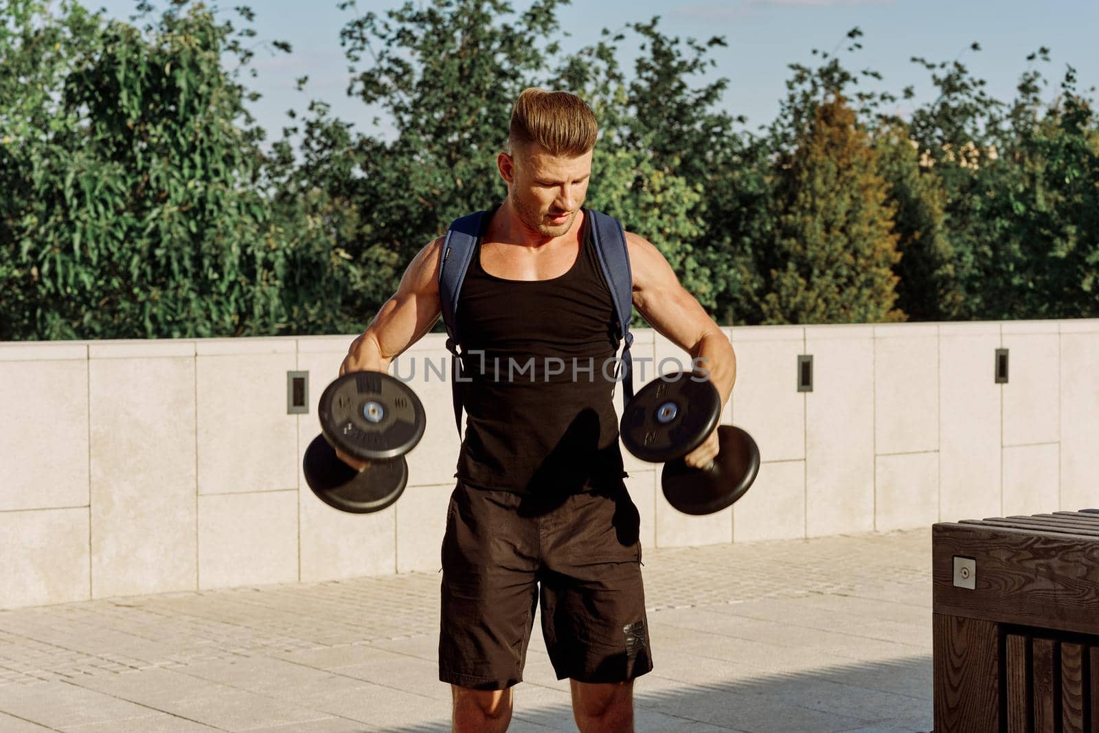 athletic man with dumbbells with pumped up body workout. High quality photo