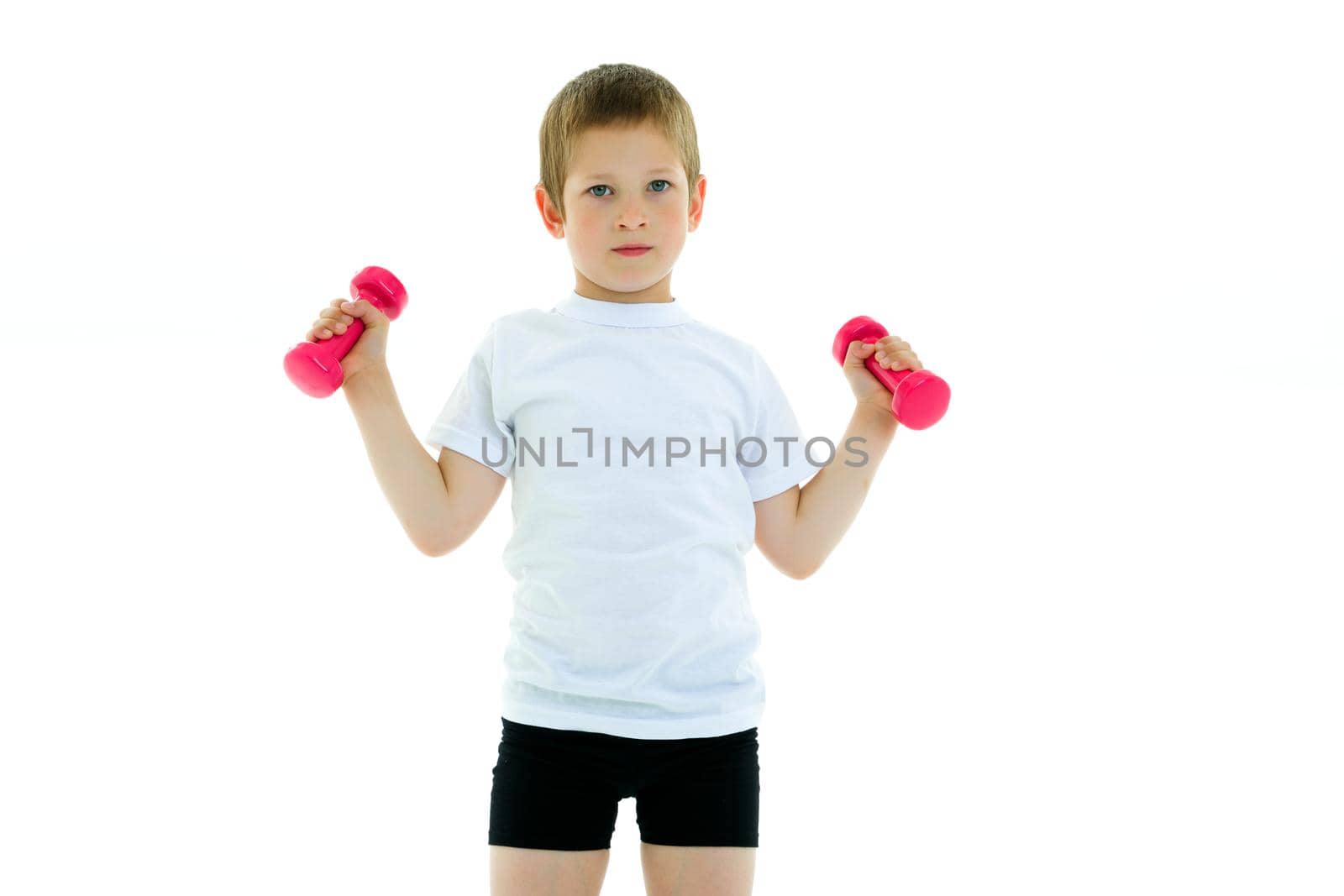 The little boy is engaged in fitness, he lifts dumbbells in the gym. The concept of a happy childhood, the development of children's sports. Isolated on white background.