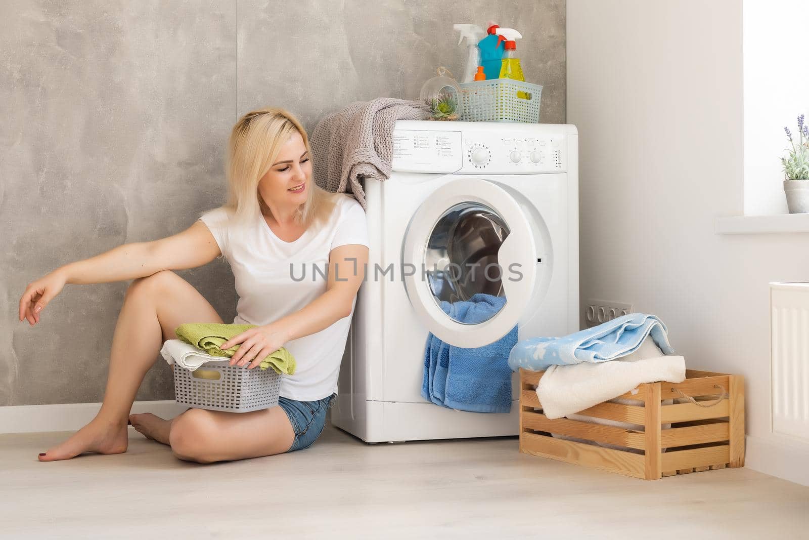 Housework, young woman doing laundry