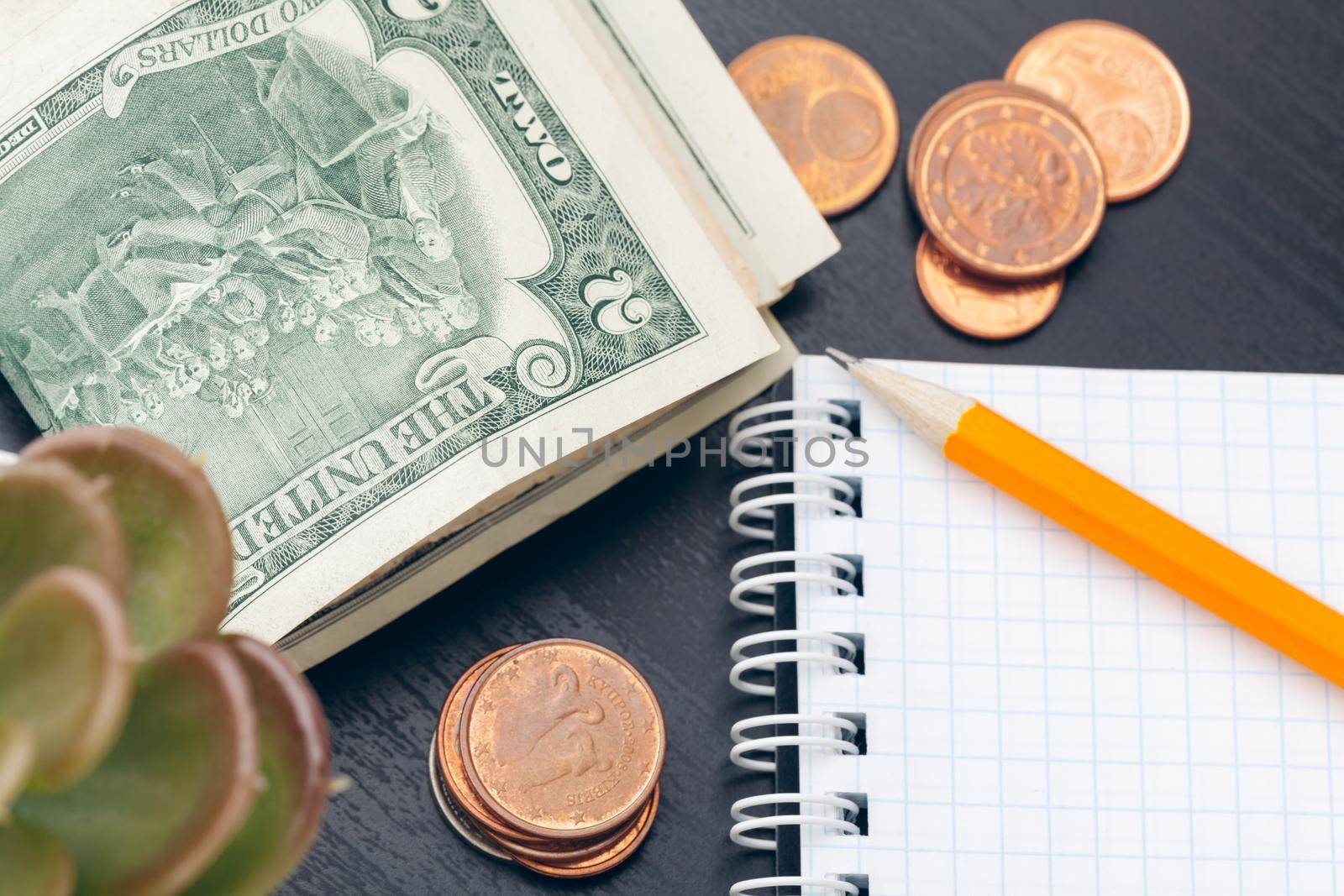 The close-up of accounting documents with money coins