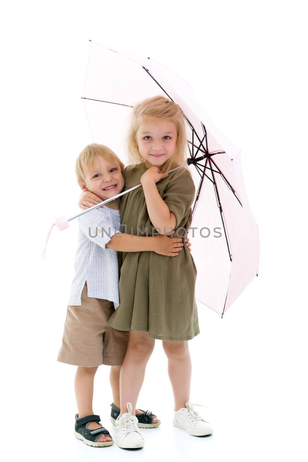 A girl and boy, brother and sister hid from the rain under an um by kolesnikov_studio