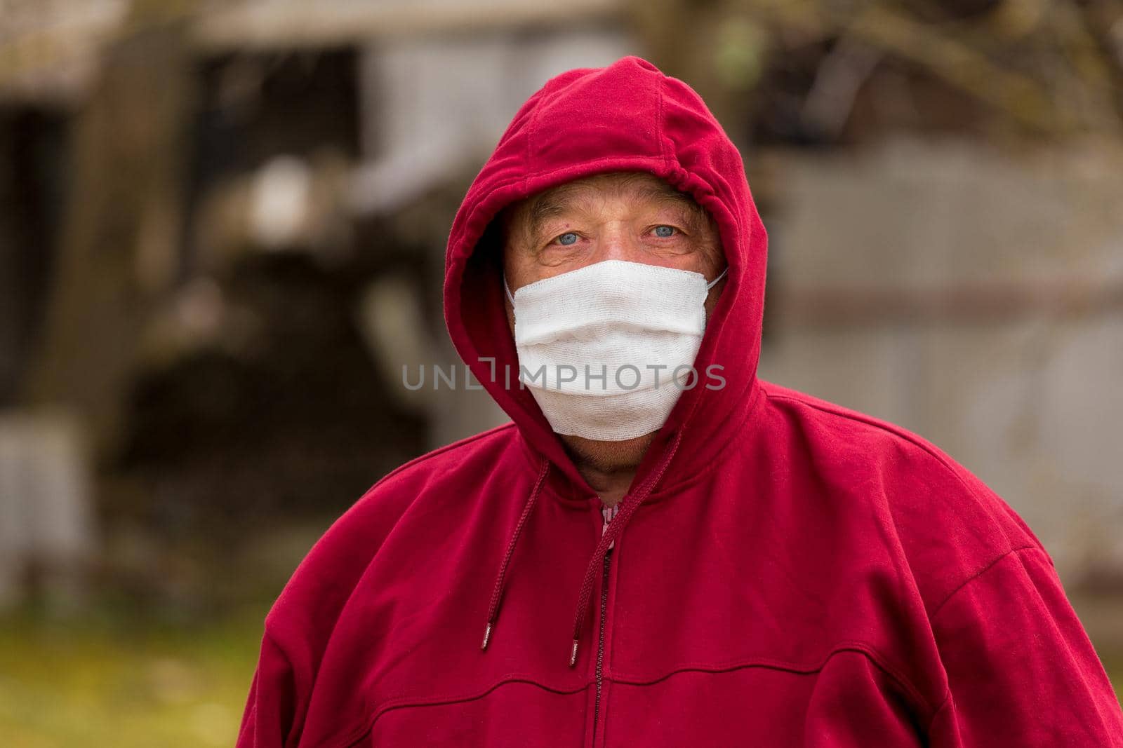 Portrait of an elderly European man with a short haircut in a protective safe medical mask, close-up.