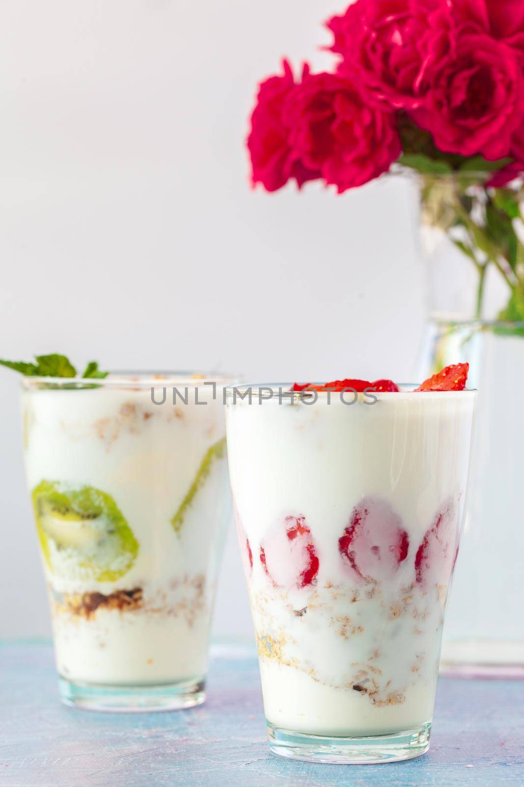 healthy products for breakfast, granola and fresh berries on white table