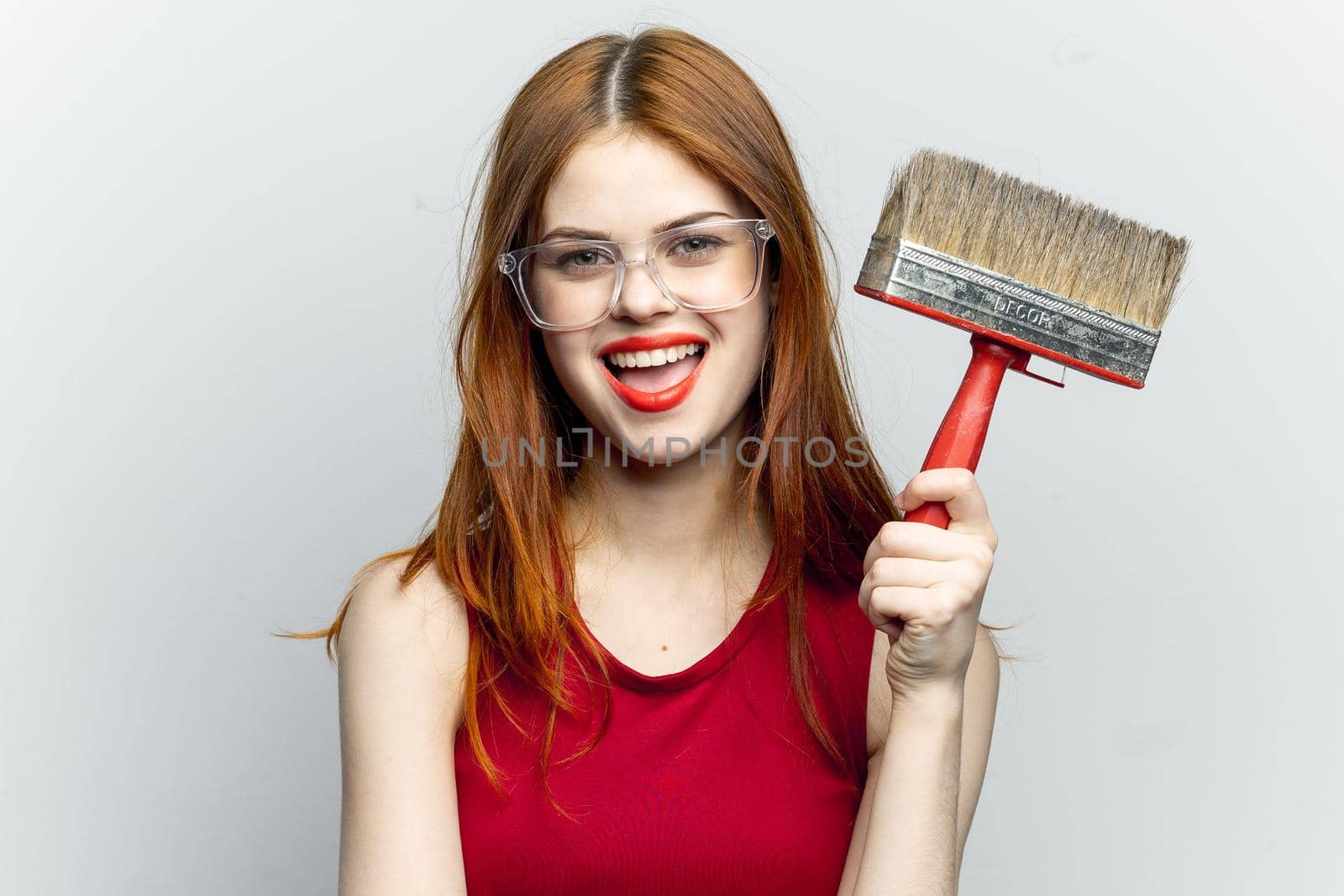cheerful woman with paint brush housework interior renovation. High quality photo