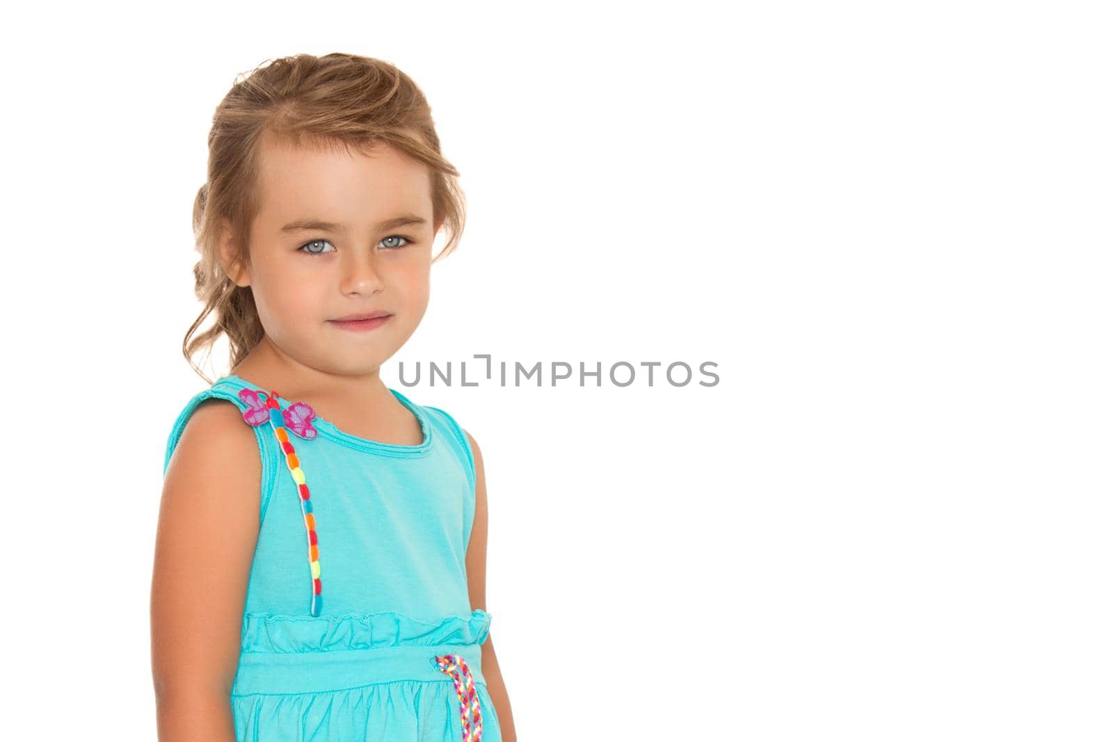 Gentle little girl with beautiful grey eyes . In the summer blue dress. Takes a step forward - Isolated on white background