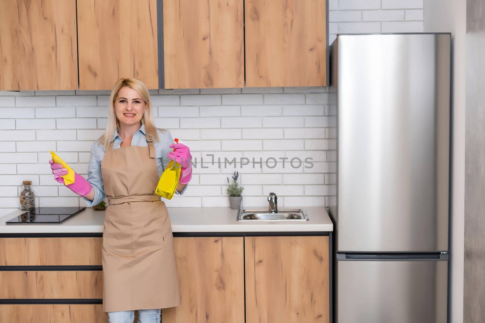 Young woman Cleaning Kitchen Cabinets