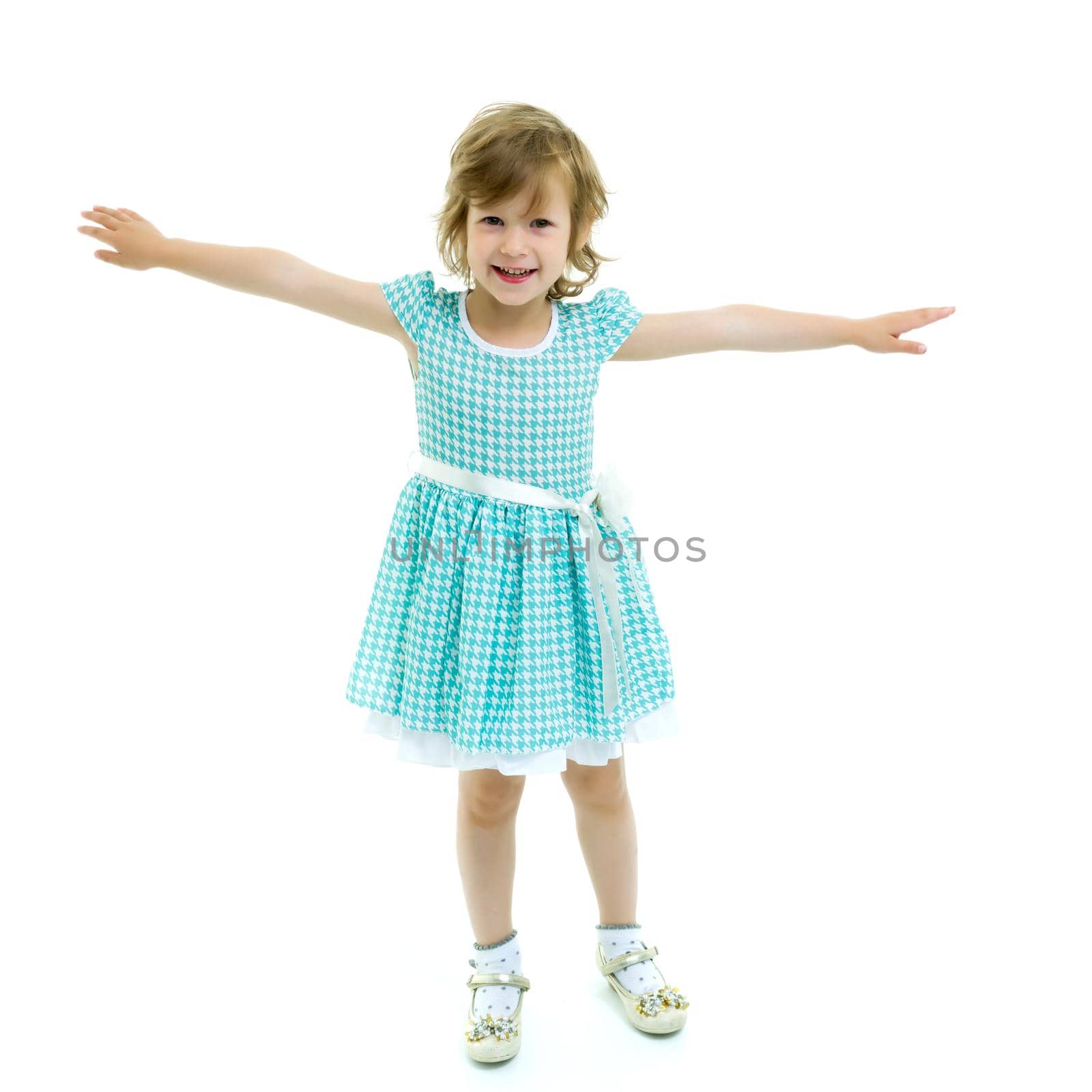 A cheerful little girl is dancing. by kolesnikov_studio