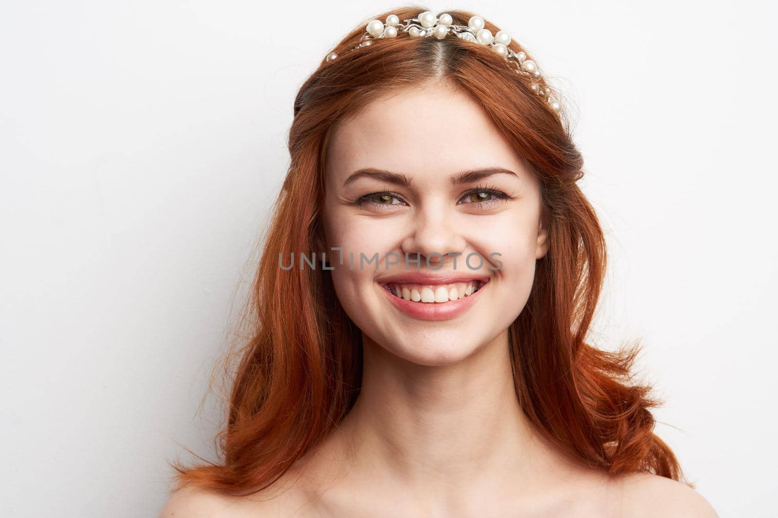 woman bare shoulders red hair makeup glamor smile model. High quality photo