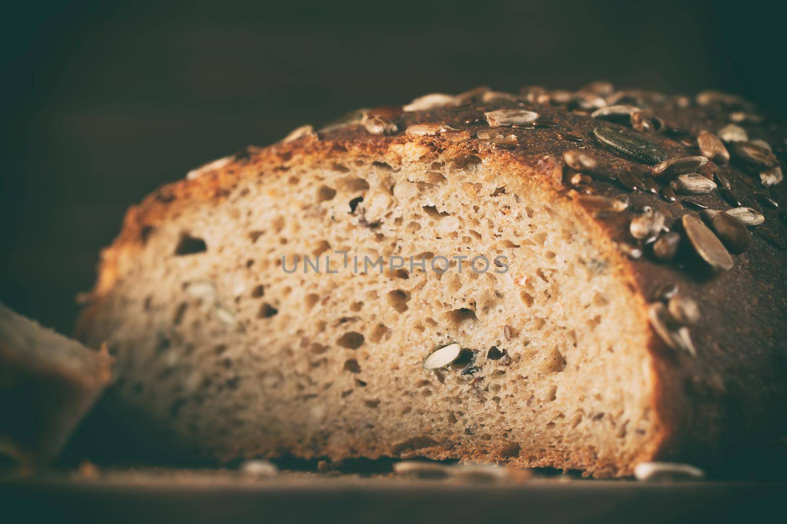 Close-up of homemade whole grain bread crumb with seeds. Selective focus by galsand