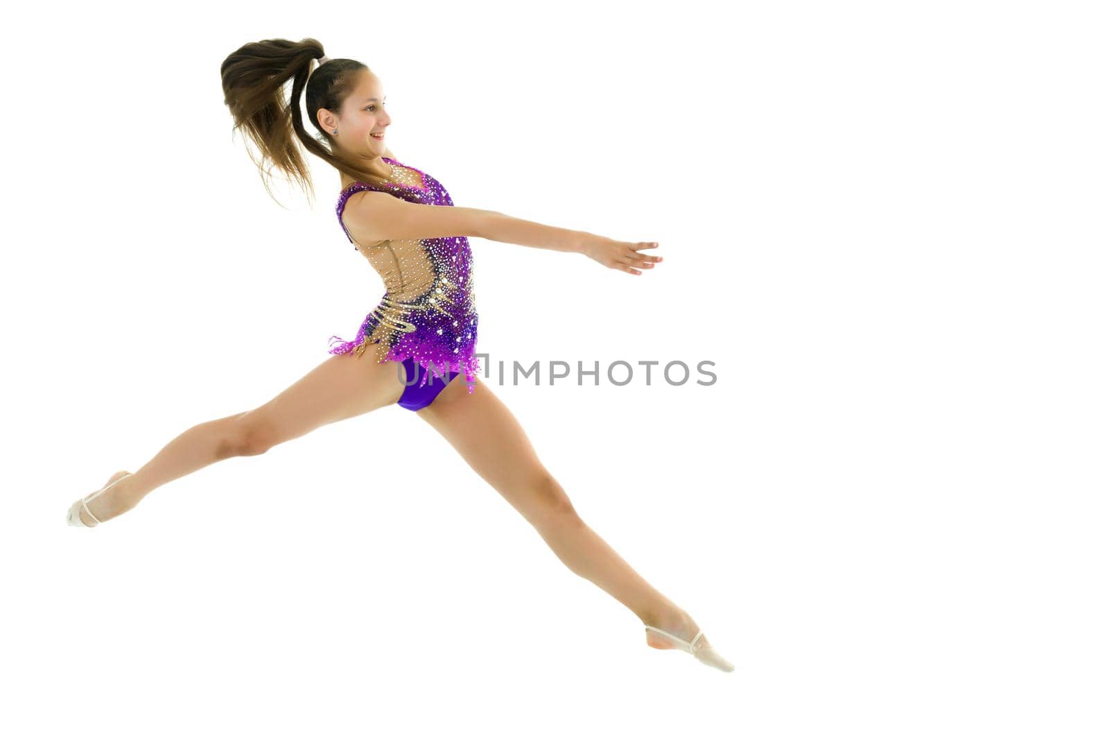 The girl gymnast performs a jump. by kolesnikov_studio