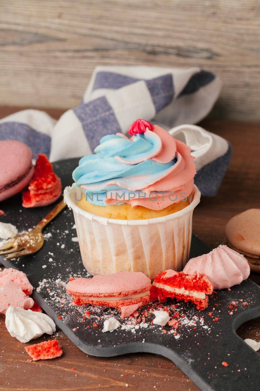 Tasty cupcakes on a dark wooden table