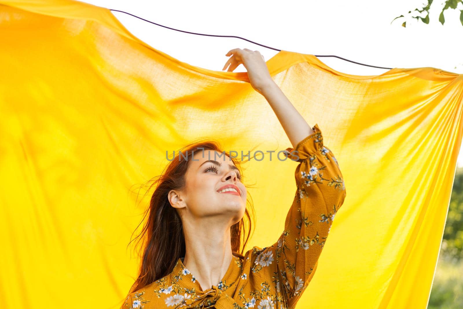 cheerful woman gesturing with her hands yellow background by Vichizh