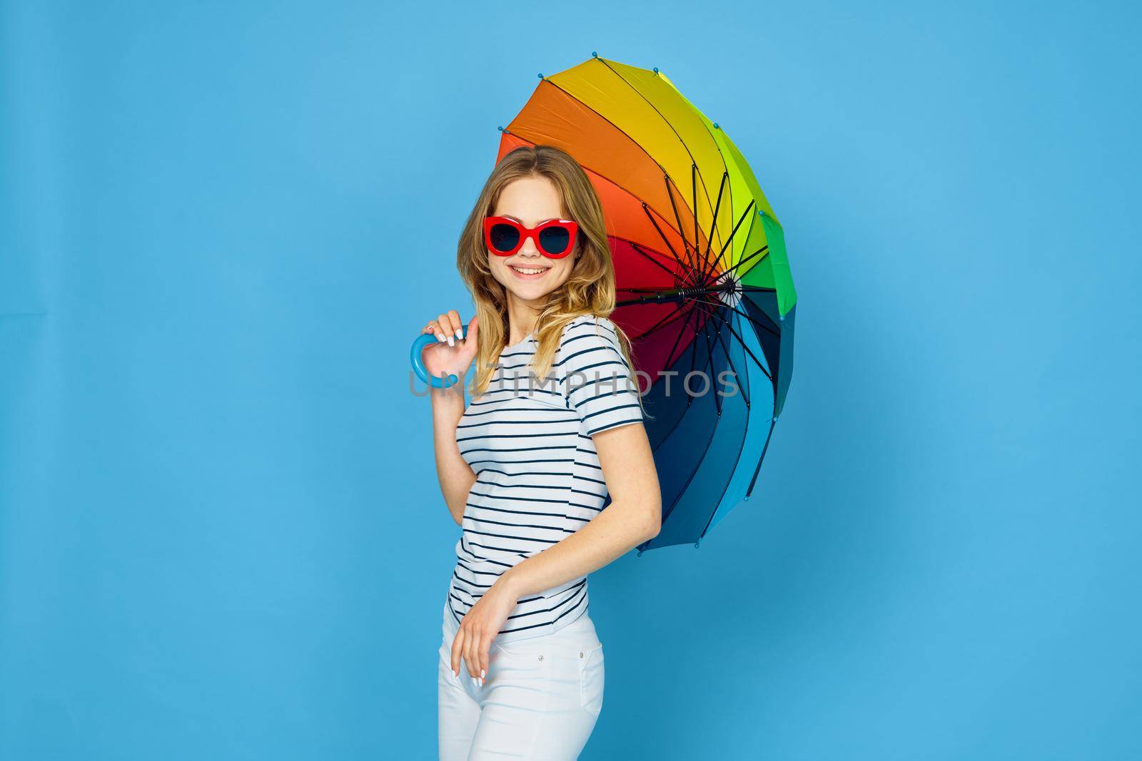 pretty woman fashion posing colorful umbrella blue background by Vichizh