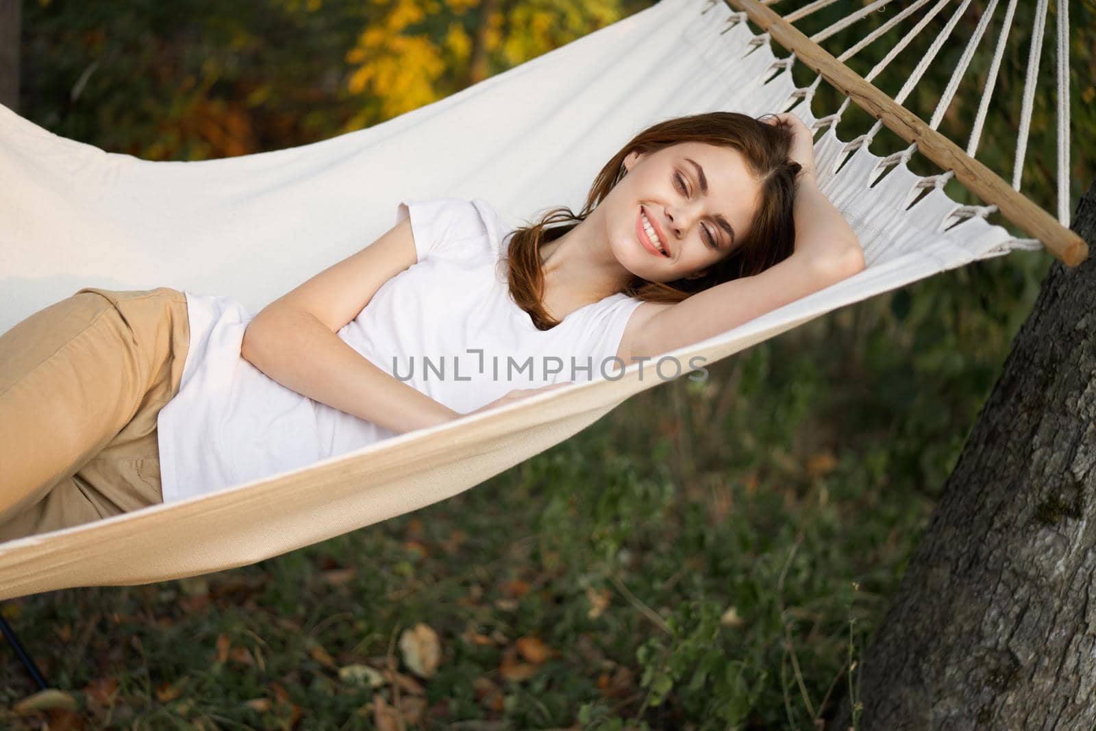 cheerful woman lies in a hammock rest nature fresh air. High quality photo