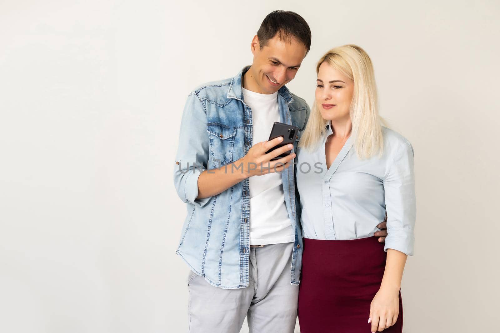 Happy couple using smartphone together