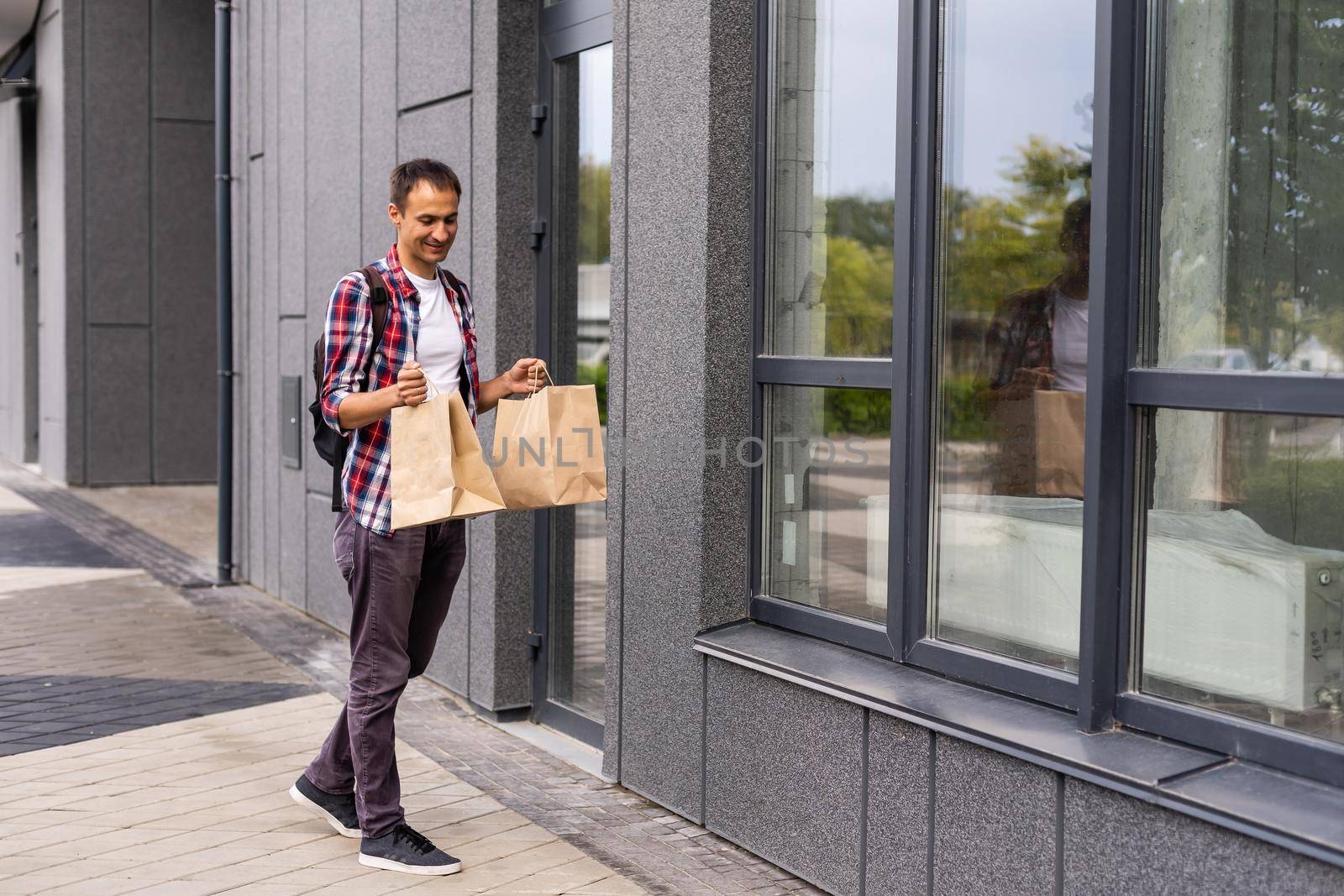 delivery man with paper containers for takeaway food.