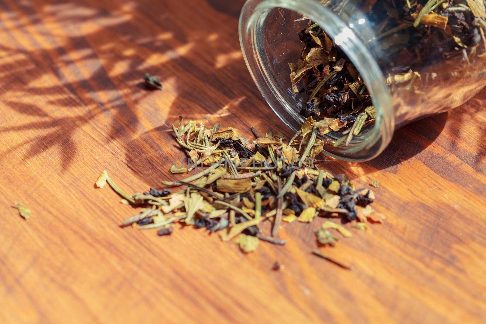Handful of natural tea on a wodden surface